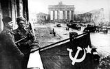 "Soviet soldiers hosting the Soviet flag on the balcony of Hotel Adlon."